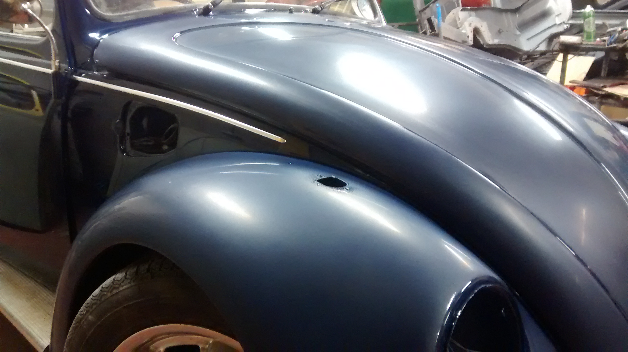 After paint we refitted the doors, bonnet and wings. The doors and quarters have been flatted and polished here, with the wings and bonnet flatted ready for a machine polish